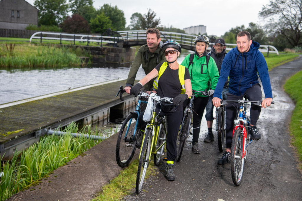 Photograph: Staff from Clydebank Housing Association and Centre81 join a led ride from Centre 81 alongside a canal