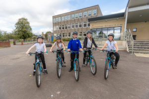Photograph: Five children on bikes in front of Clackmannan Primary School