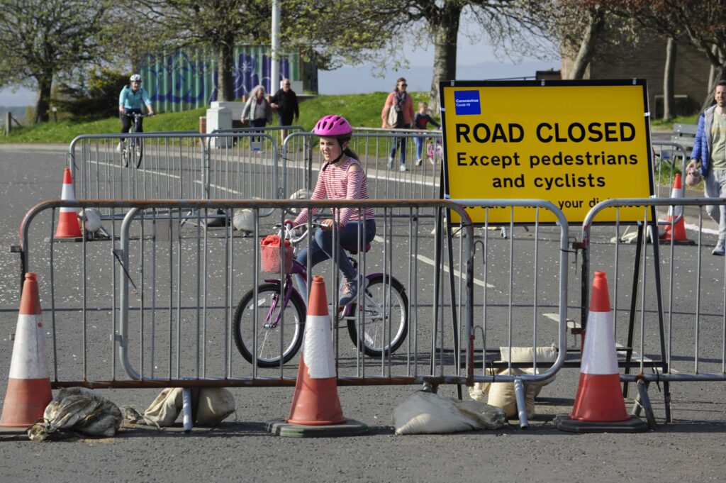A child cycles on a closed road in Edinburgh