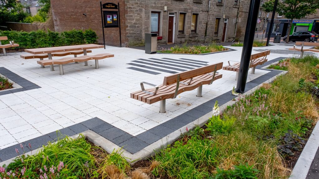 The new benches and gardens that have been installed on Craigie Street in Dundee are shown, alongside a large floor mural.