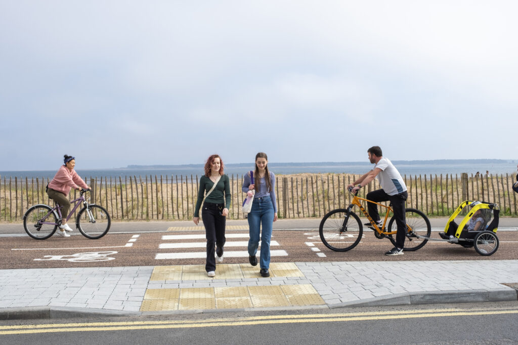 Two girls crossing a segregated cycle lane on newly upgraded public space in Broughty Ferry.