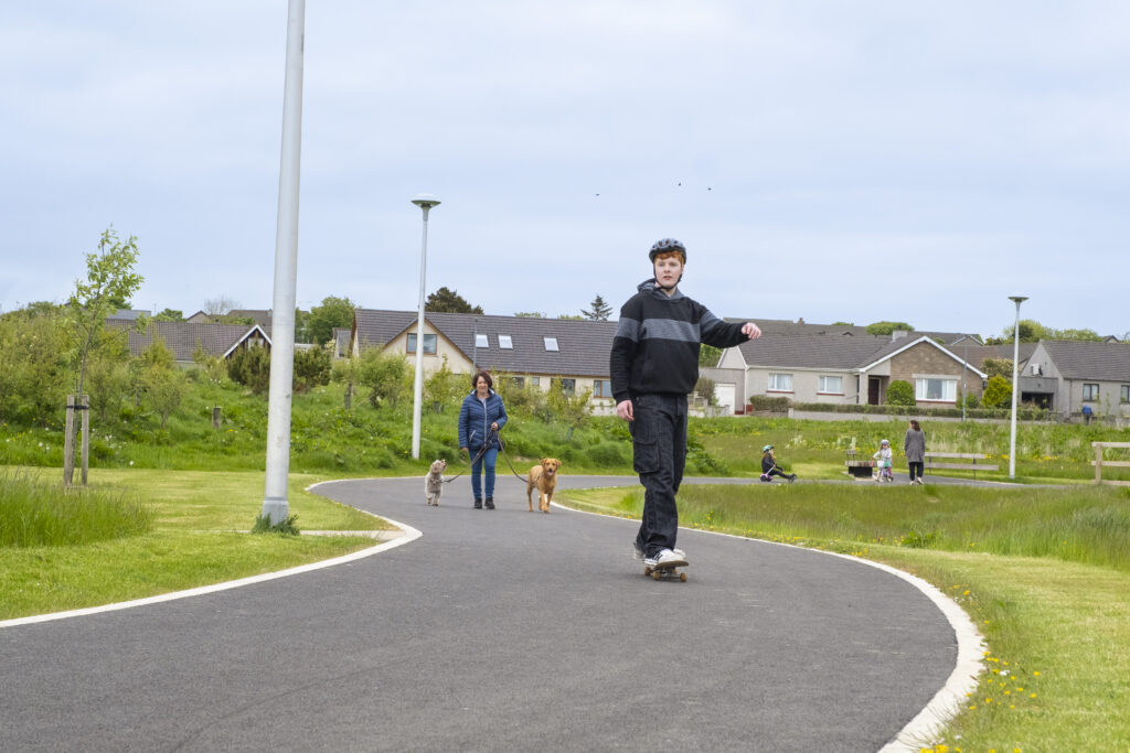 Young person skateboarding in public space - Papdale Park, Orkney. 