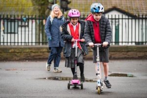 Two children on scotters