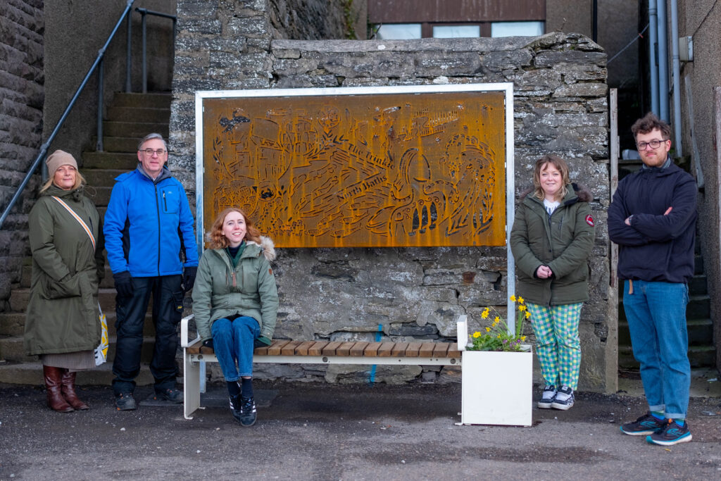 Pictured with Hannah Cambridge’s artwork are, l-r, Royal Burgh of Wick Community Councillors Joanna Coghill and Allan Farquhar, Marion Eele, Project Lead, Co-Design, Sustrans Scotland, artist Hannah Cambridge and Thomas Parkin, Senior Urban Designer, Sustrans. Credit: Sustrans