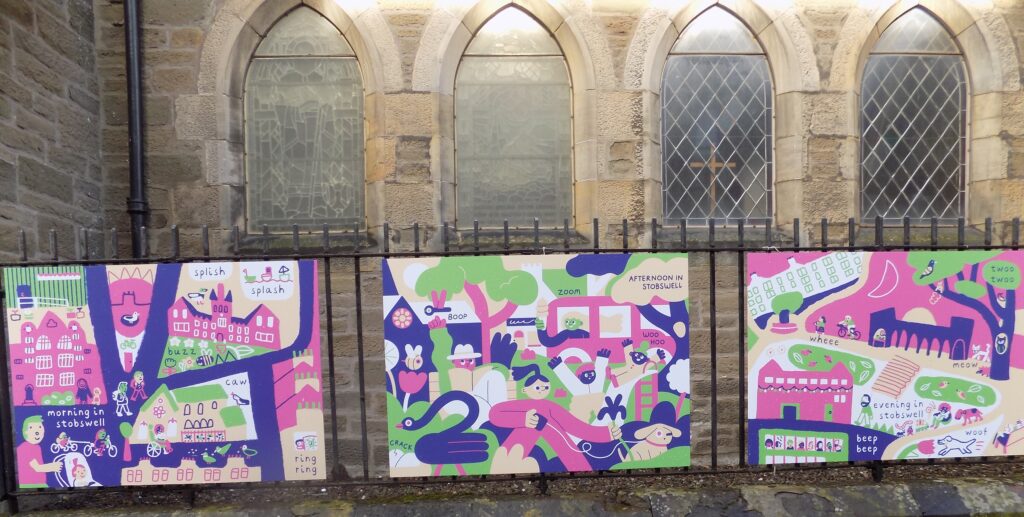Three artwork panels are shown on display outside of Stobswell Parish Church.